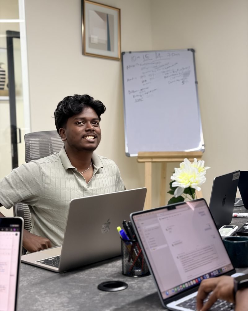 An Expericia engineer at his desk in the Kochi office, the sprint board behind him