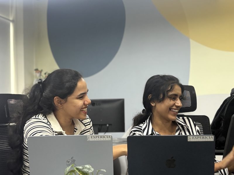 Two Expericia engineers working side by side on a storefront build