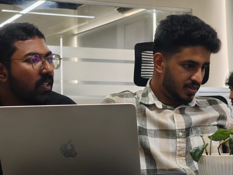 Two engineers discussing a change over a laptop