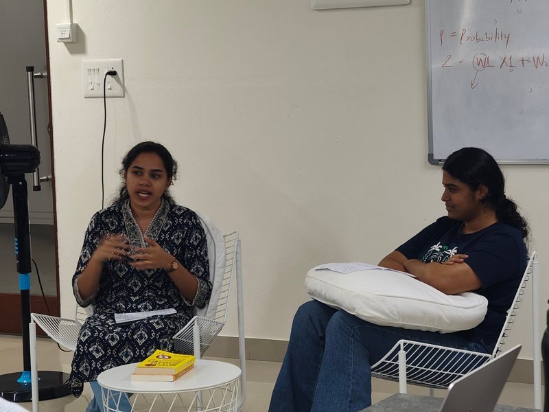 Two team members talking it through in the lounge corner
