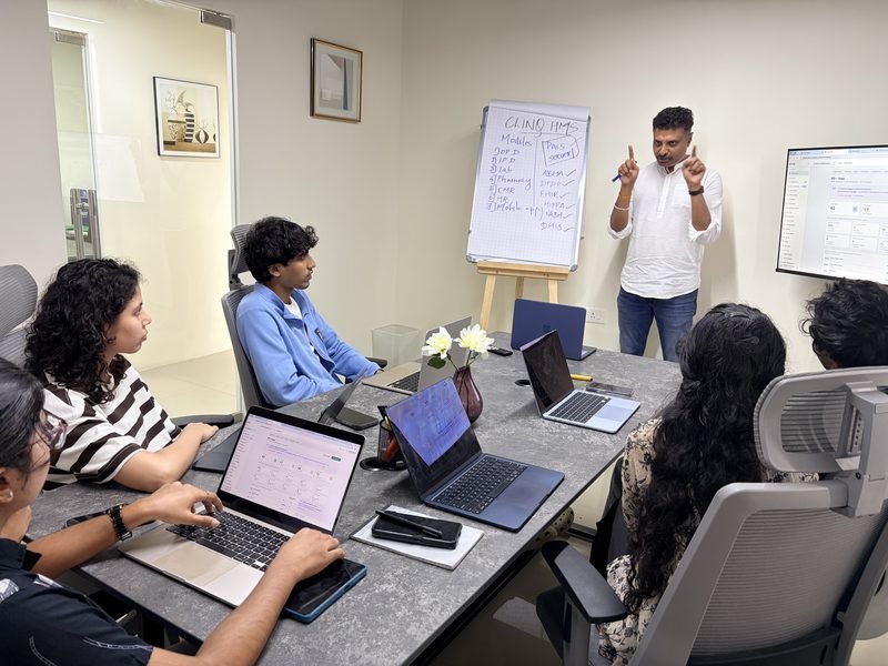 Karthick walking the team through ClinQ HMS modules in the Kochi meeting room