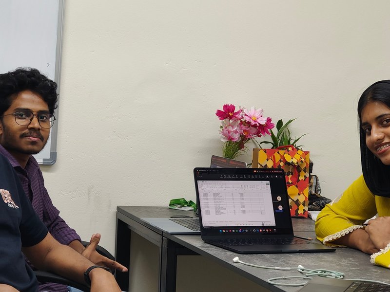 Colleagues catching up around the desk at the Kochi office