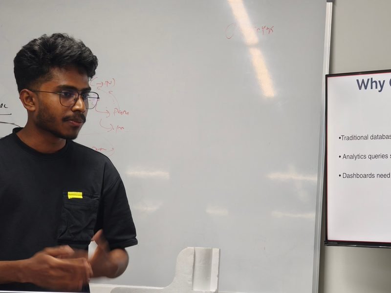 An engineer presenting a tech talk on ClickHouse to the team