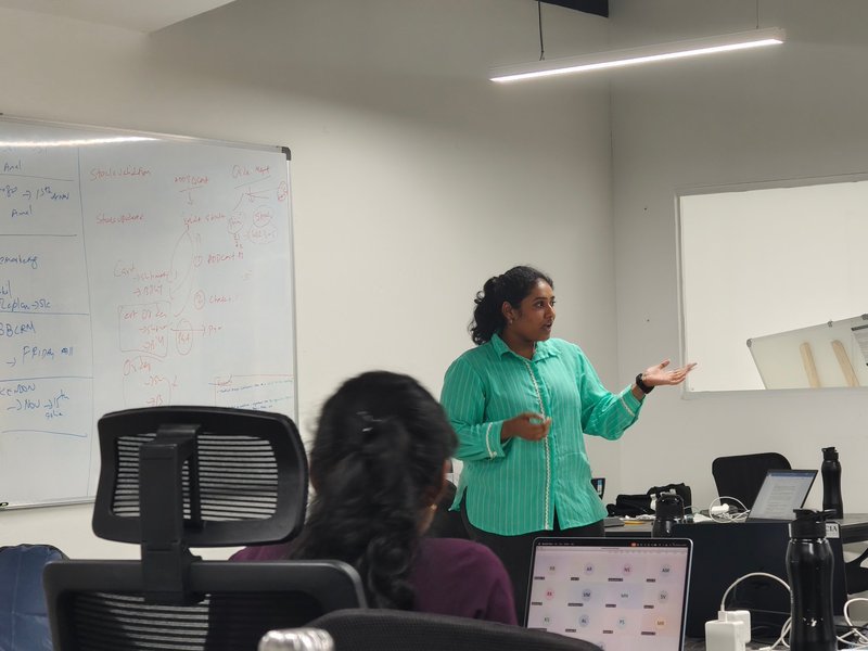 An Expericia analyst walking the team through a build on the whiteboard at the Kochi office