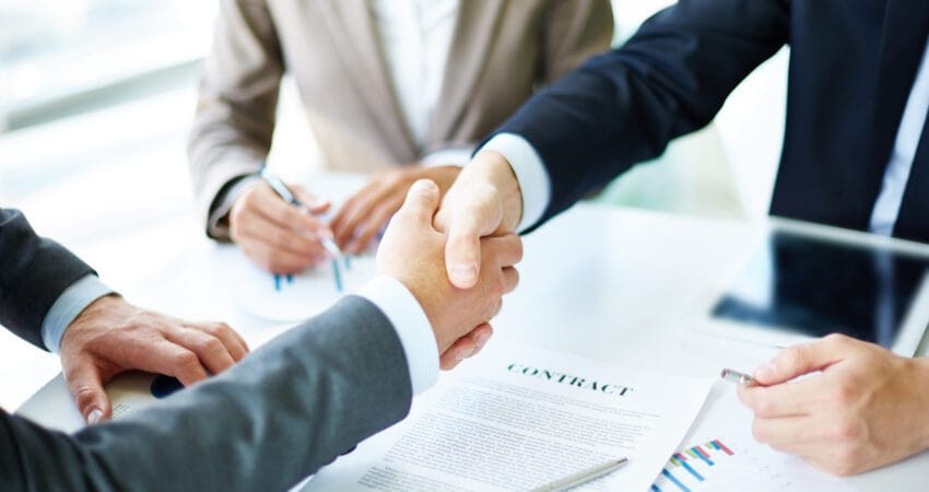 Two people signing the deal to procure an equipment